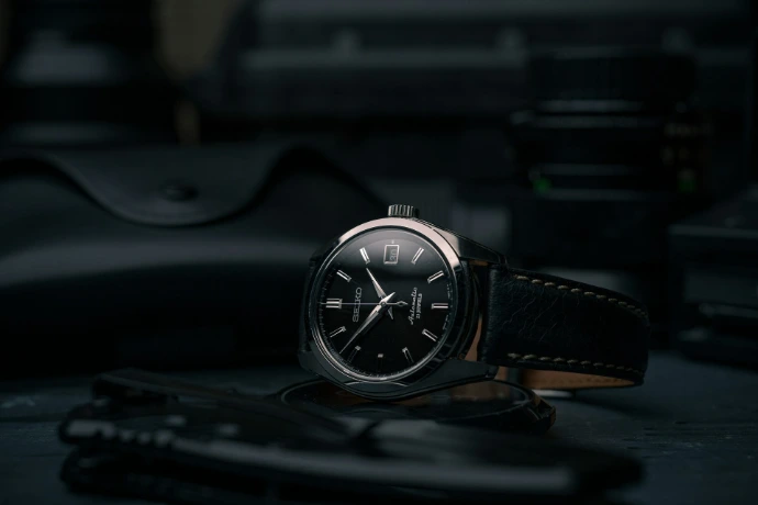 black and silver round analog watch